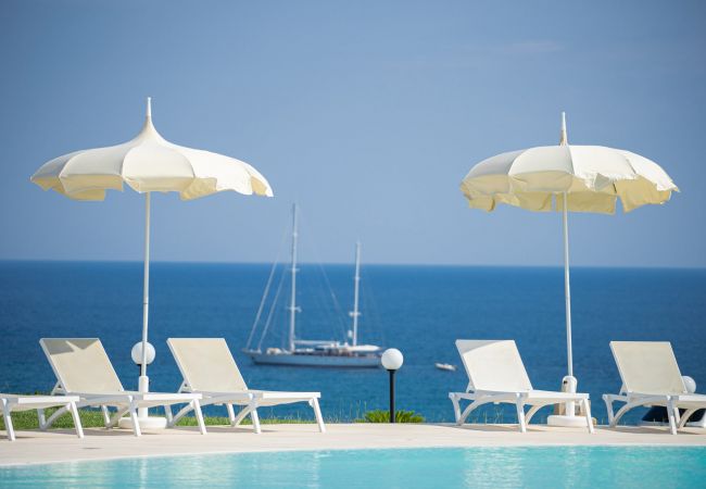 Relaxing moments by the poolside with a sea view